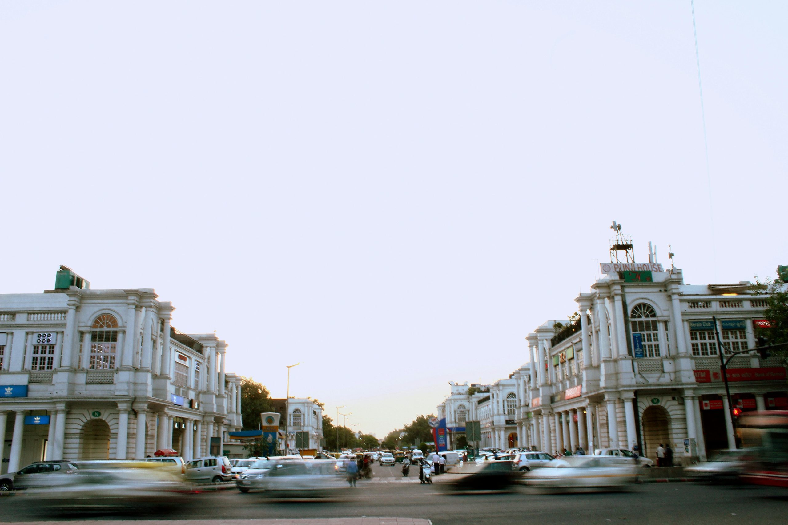 Traffic flows through the historic Connaught Place intersection as dusk settles, capturing the city's vibrant life.Best Destination in Delhi to Visit